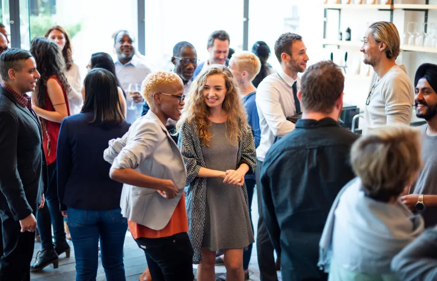 a group of people of various complexions meeting and talking