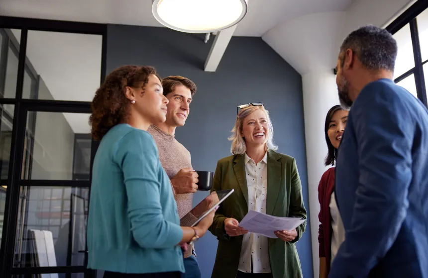 a group of business people in a circle talking